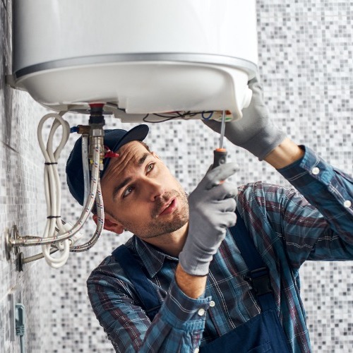 plumber working on a water heater